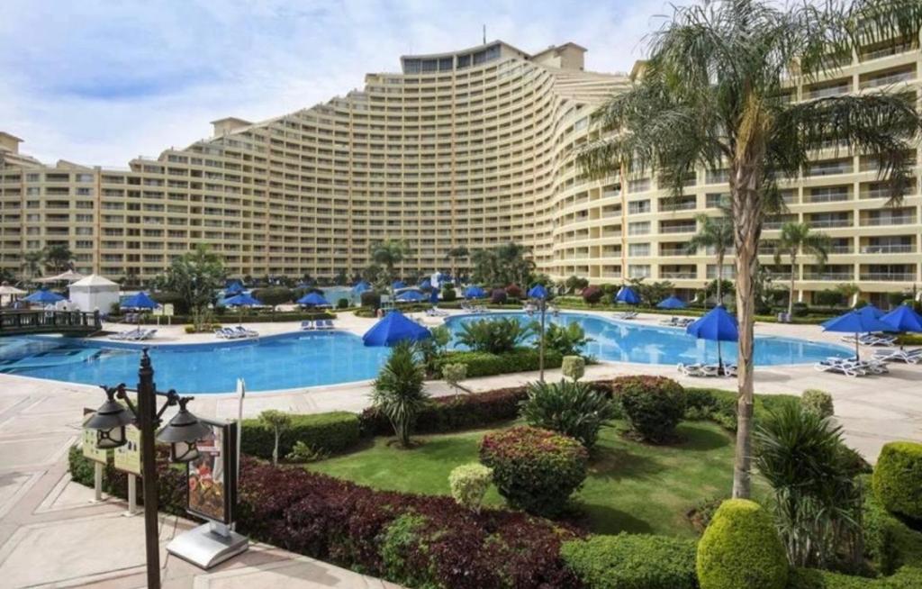 a large hotel with a large pool and a resort at Amer Group Sokhna - عطلة أحلامك in Ain Sokhna
