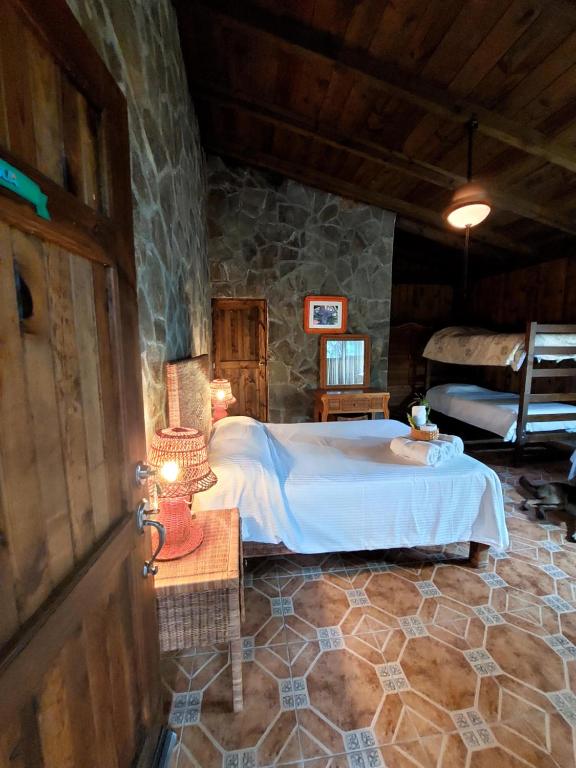 a bedroom with a bed in a stone room at Mango Selva Bio Hotel in Actopan