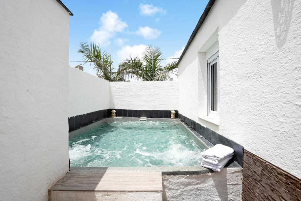 a swimming pool in the side of a building at Villa Bali in Chiclana de la Frontera