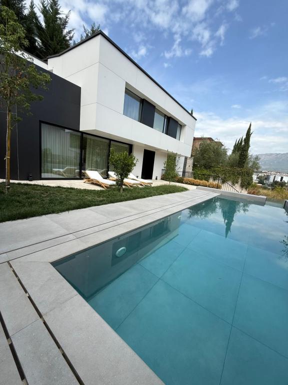 a house with a swimming pool in front of it at Luxury Villa Silente in Mjull-Bethore