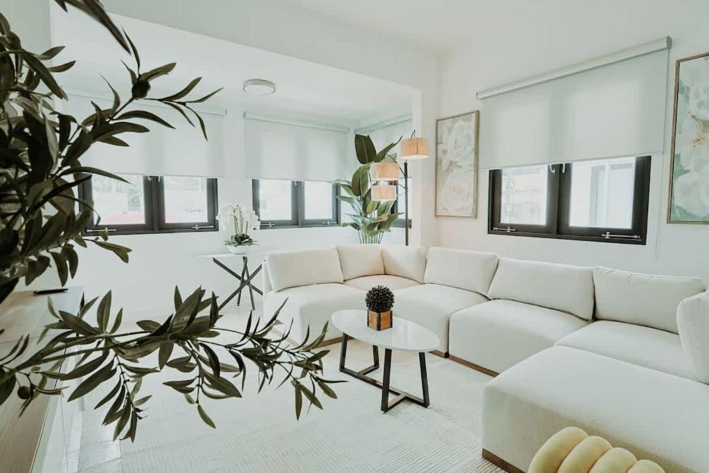 a living room with a white couch and a table at Elegant Home with KingBed Private Patio Ensuites in San Juan