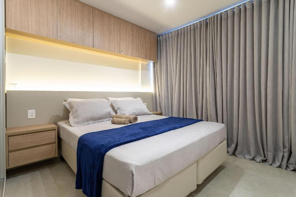 a bedroom with a bed with a teddy bear on it at Apê com piscina e academia: Metrô 350m in Rio de Janeiro