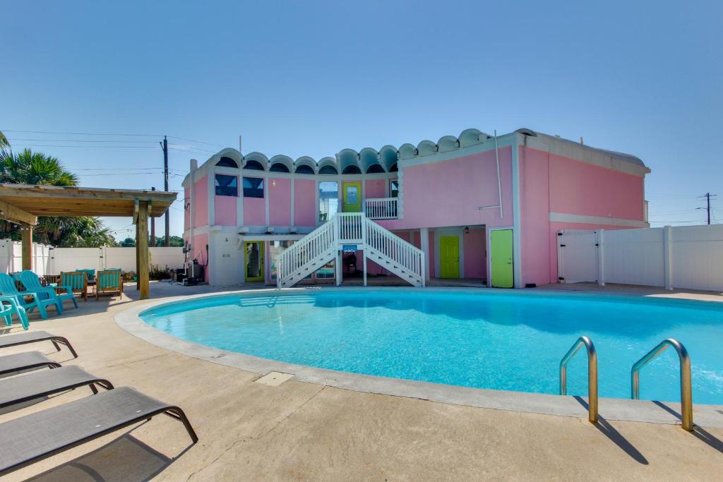a large swimming pool with chairs next to a building at Walk to Beach Unique Family Gem in Pass Christian in Long Beach
