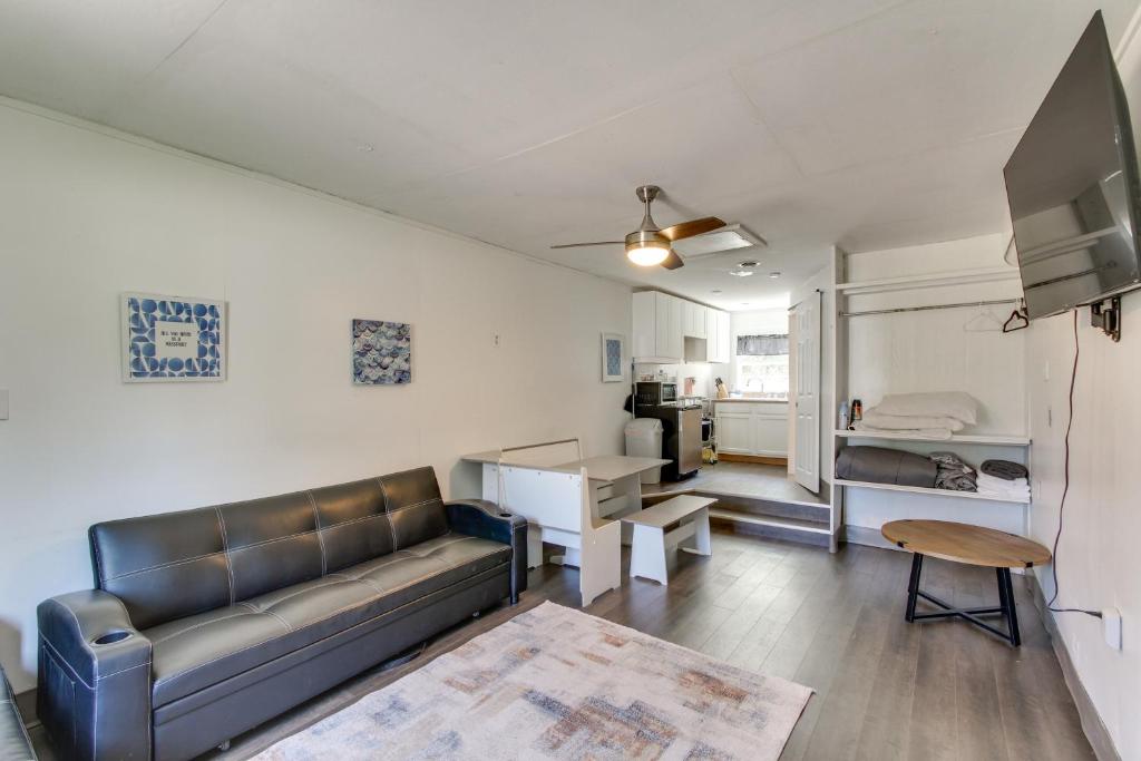 a living room with a couch and a table at 2 Mi to Long Beach Waterfront! Convenient Studio in Long Beach