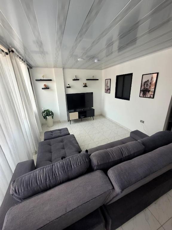 a living room with a couch and a flat screen tv at Apto Garcia Alzate in Santa Rosa de Cabal
