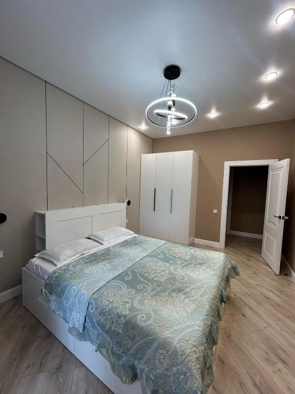 a bedroom with a large bed and a ceiling at Perfect HoLiDaY in Almaty