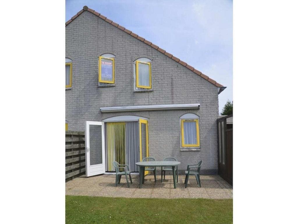 a house with a table and chairs in front of it at Holiday home in Breskens with Wi-Fi in Breskens