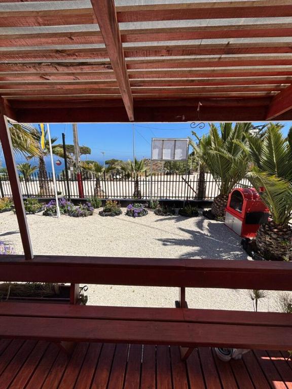a view of a patio from a deck with a bench at Tropical Cabaña B in Coquimbo
