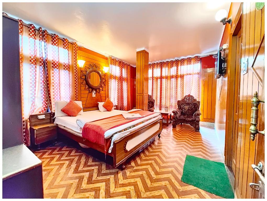 a bedroom with a bed in a room with curtains at Hotel Nainita Ankur ! Naini Lake View - On Terrace Open Restauarant with Lake View and Valley Mountain View with Wifi - Room Service Available - Best Vacation Stay with Family - Book Now in Nainital