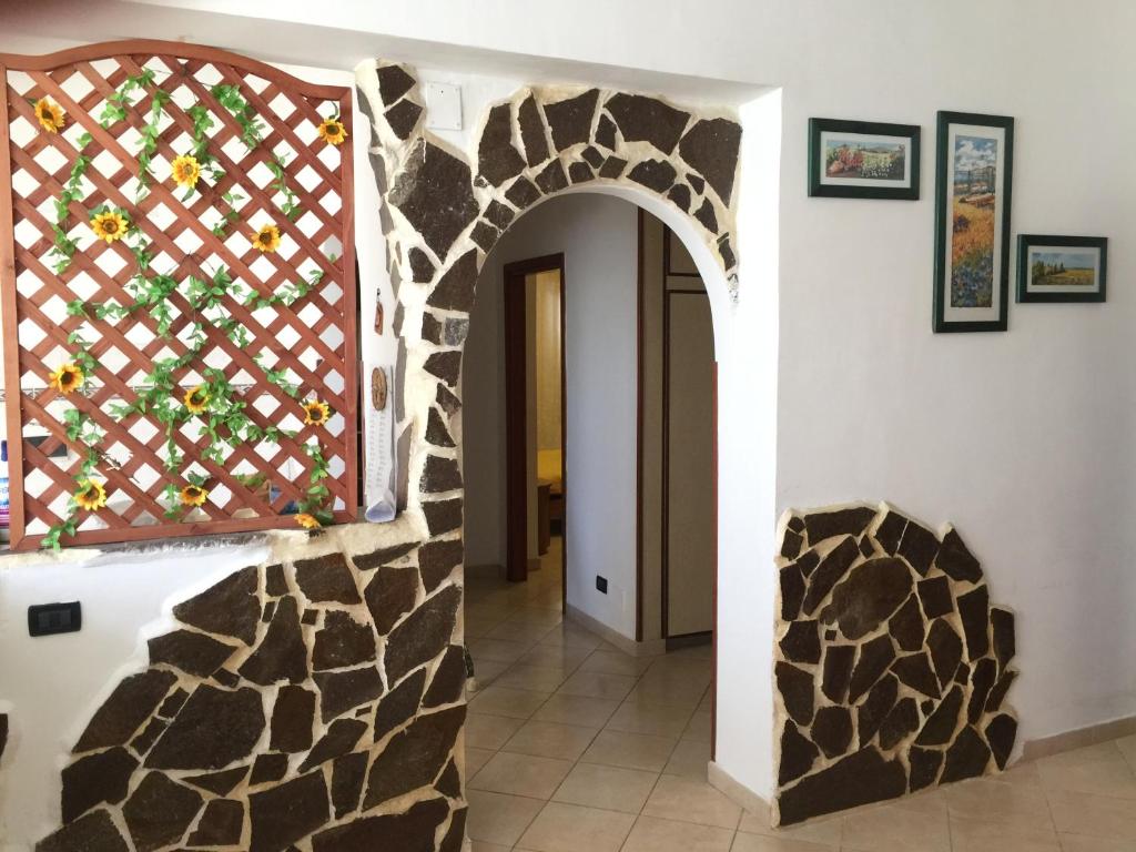 einen Flur mit einer Steinmauer und einem Torbogen in der Unterkunft Sacca House in Reggio di Calabria