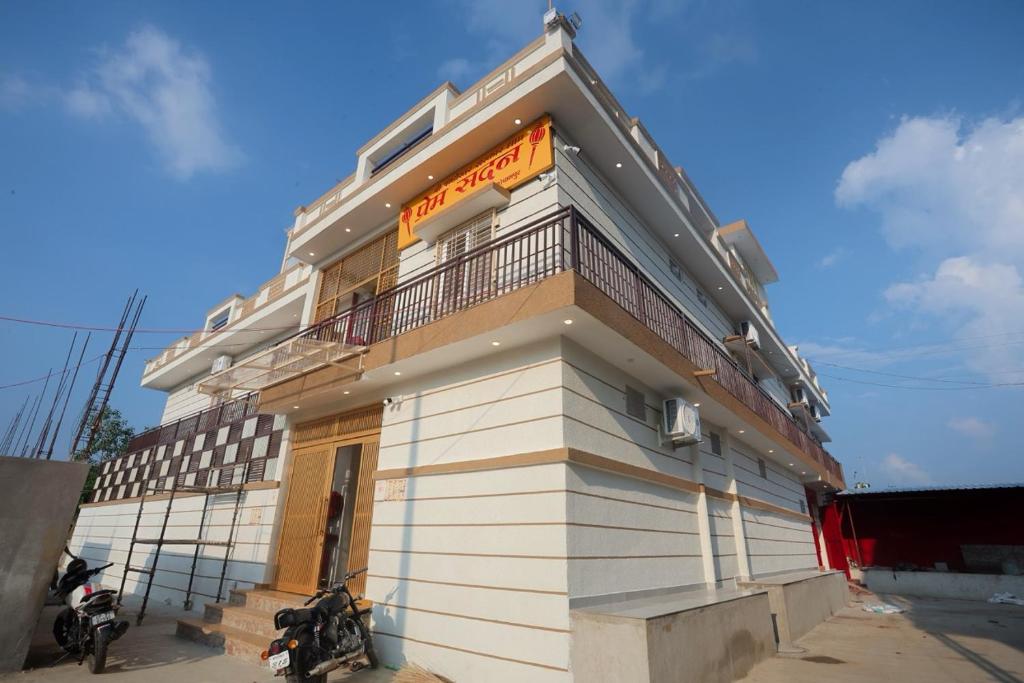 a building with a motorcycle parked in front of it at Prem Sadan, Pandokhar Sarkar Dham in Indargarh