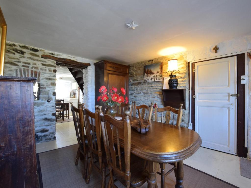a dining room with a wooden table and chairs at Beautiful and Authentic Cottage in Houffalize