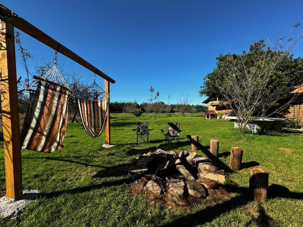 a hammock and a fire pit in a field at La Herencia de los Abuelos in Zacatlán