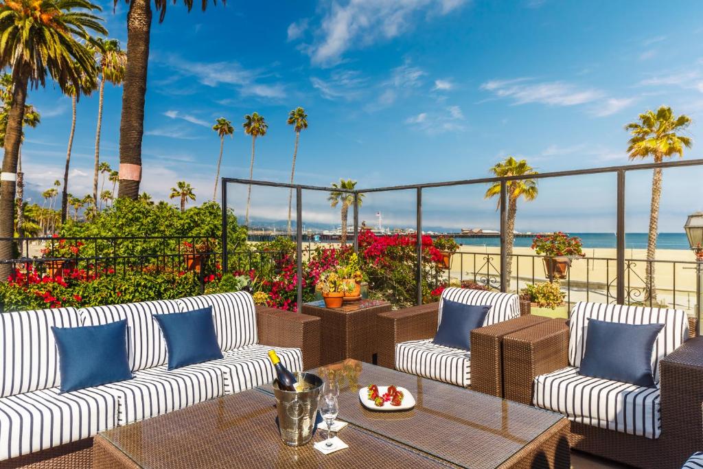 a dining room table with a balcony overlooking the ocean at Hotel Milo Santa Barbara in Santa Barbara