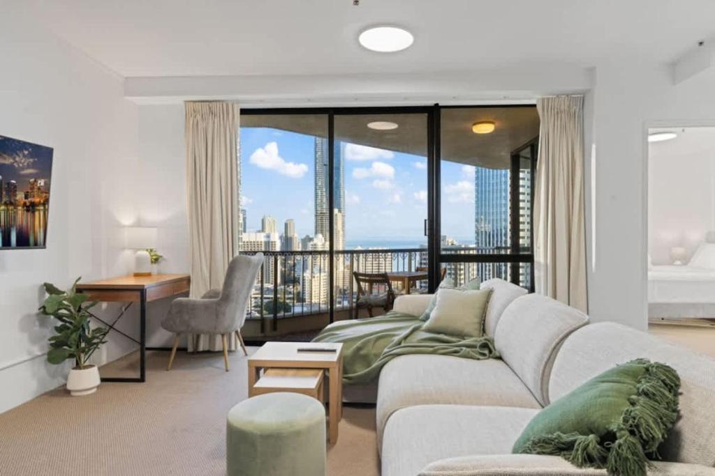 a living room with a couch and a large window at The Beachside - High Floor Ocean View 2BDR with Parking Pool & Gym in Gold Coast