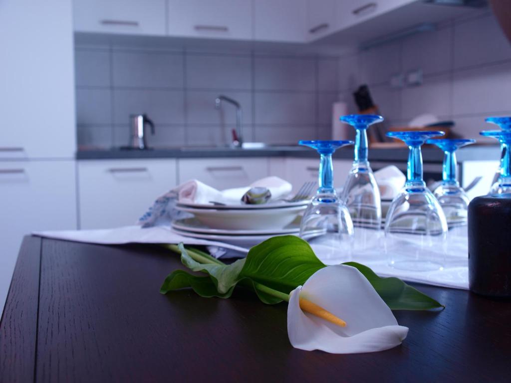 a table with a plate and some wine glasses at Apartments Bea in Lovran