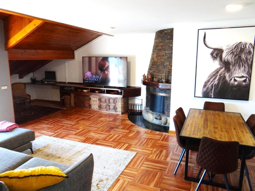 a living room with a table and a fireplace at Apartamento Puigcerdà ideal familias in Puigcerdà