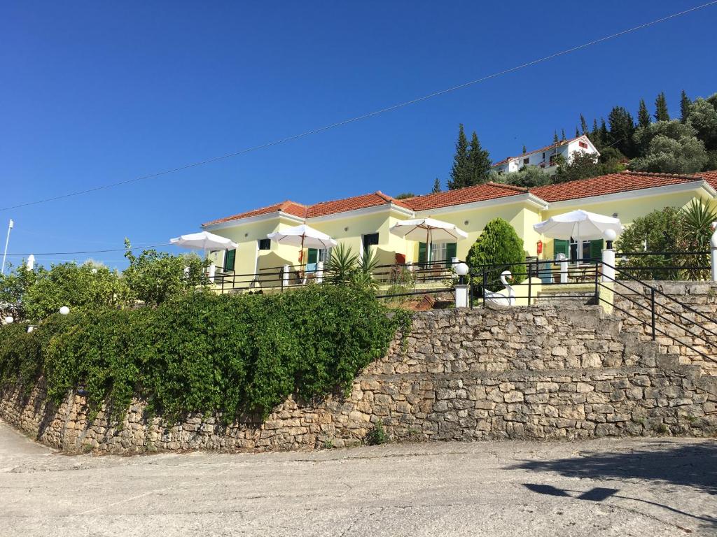 a house on top of a stone wall at Panorama in Vathi