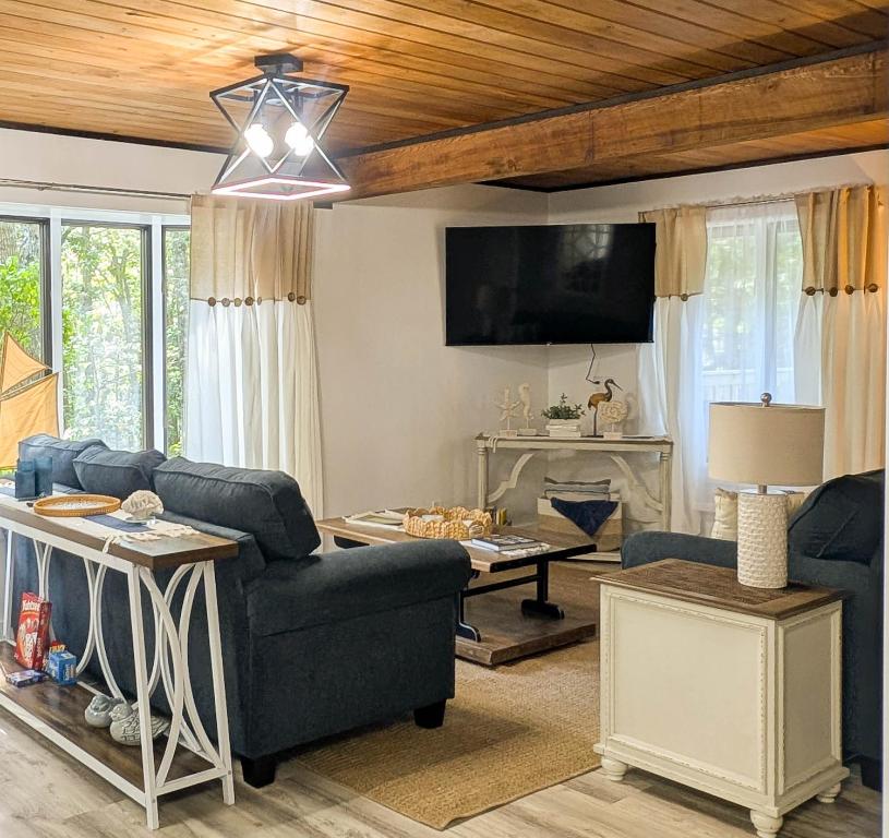 a living room with a couch and a table at Beautiful Bar Harbor House in Bar Harbor