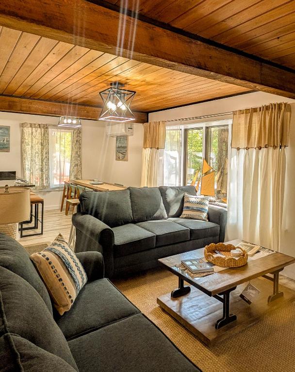 a living room with a couch and a table at Beautiful Bar Harbor House in Bar Harbor