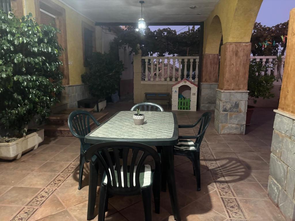 a table and chairs sitting on a patio at Alojamiento rural Villa Carmen in Mula