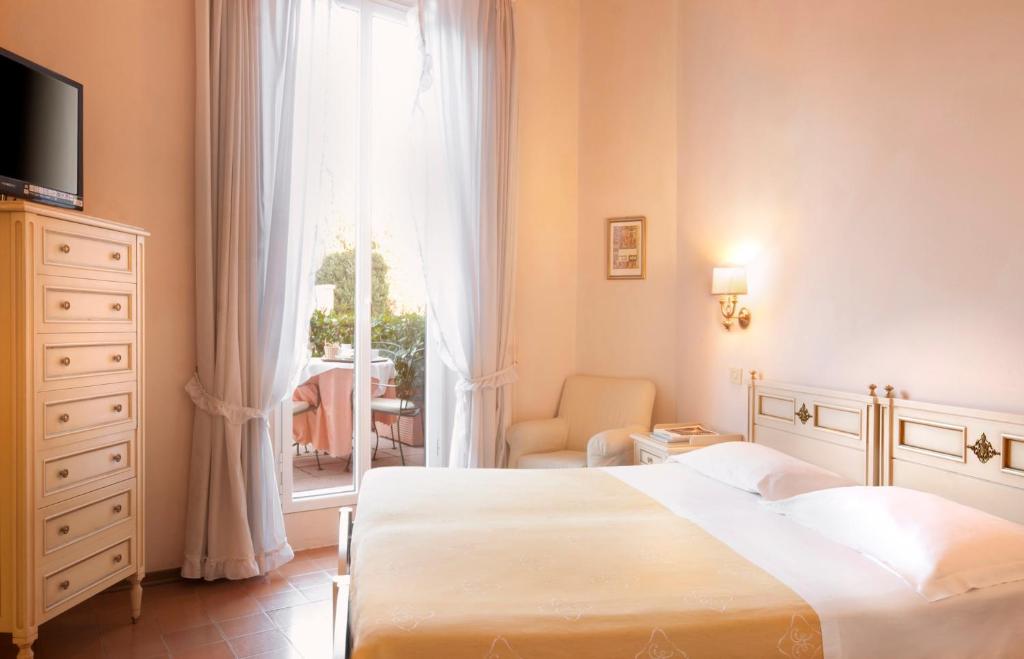 Postel nebo postele na pokoji v ubytování Hotel Settentrionale Esplanade