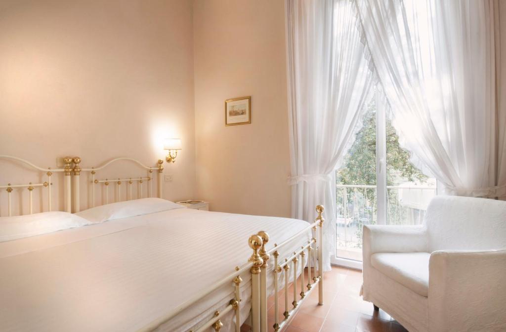 Postel nebo postele na pokoji v ubytování Hotel Settentrionale Esplanade