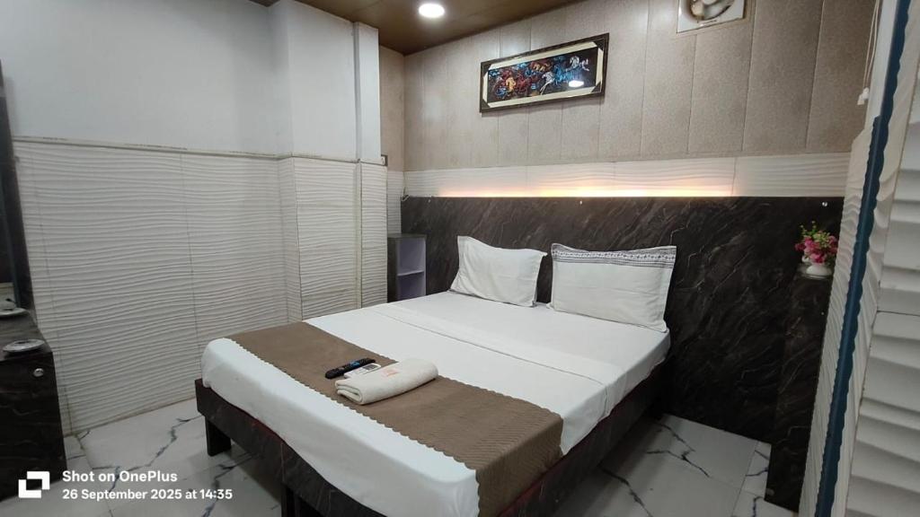 a bedroom with a bed with a phone on it at Hotel Revive By The Premium Villa in New Delhi
