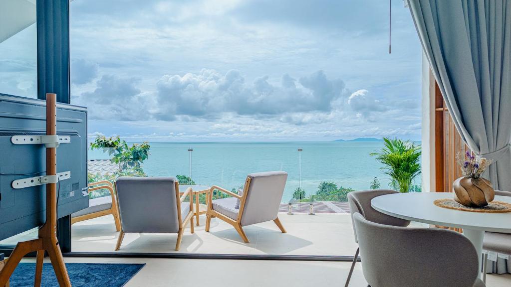 a dining room with a view of the ocean at v14 Serenity Bay Panoramic Sea View in Haad Yao