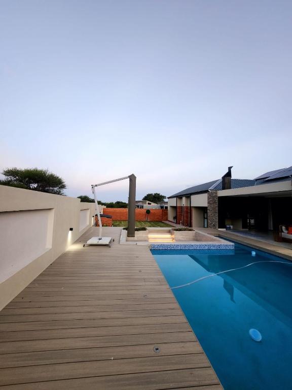 a house with a swimming pool and a wooden deck at Euphoria 447 in Naboomspruit