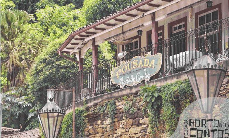 a building with a sign on the side of it at Pousada Horto dos Contos in Ouro Preto