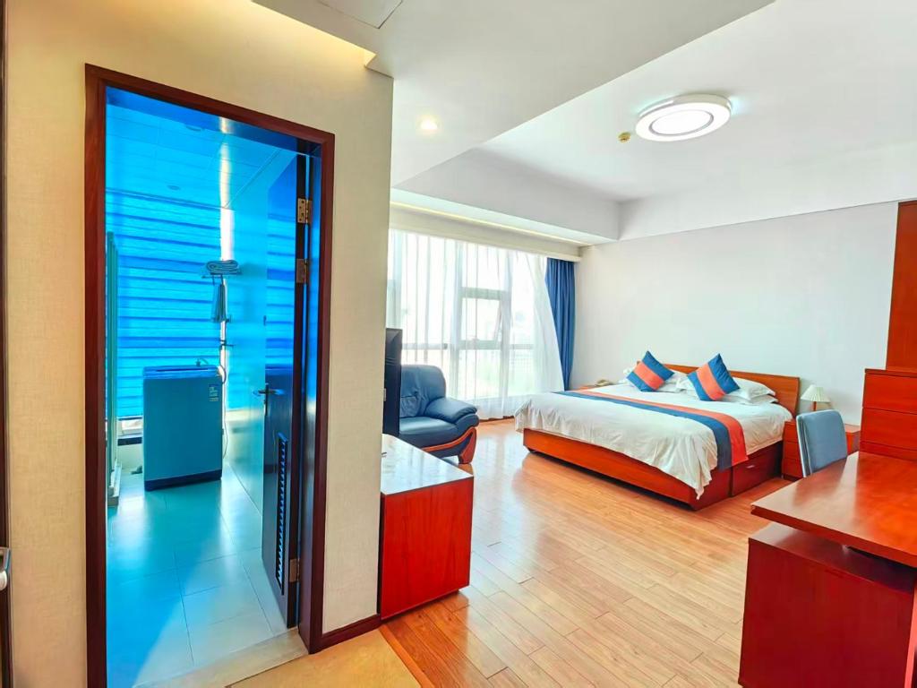 a hotel room with a bed and a glass door at East King Business Hotel (West Lake store, Hangzhou) in Hangzhou