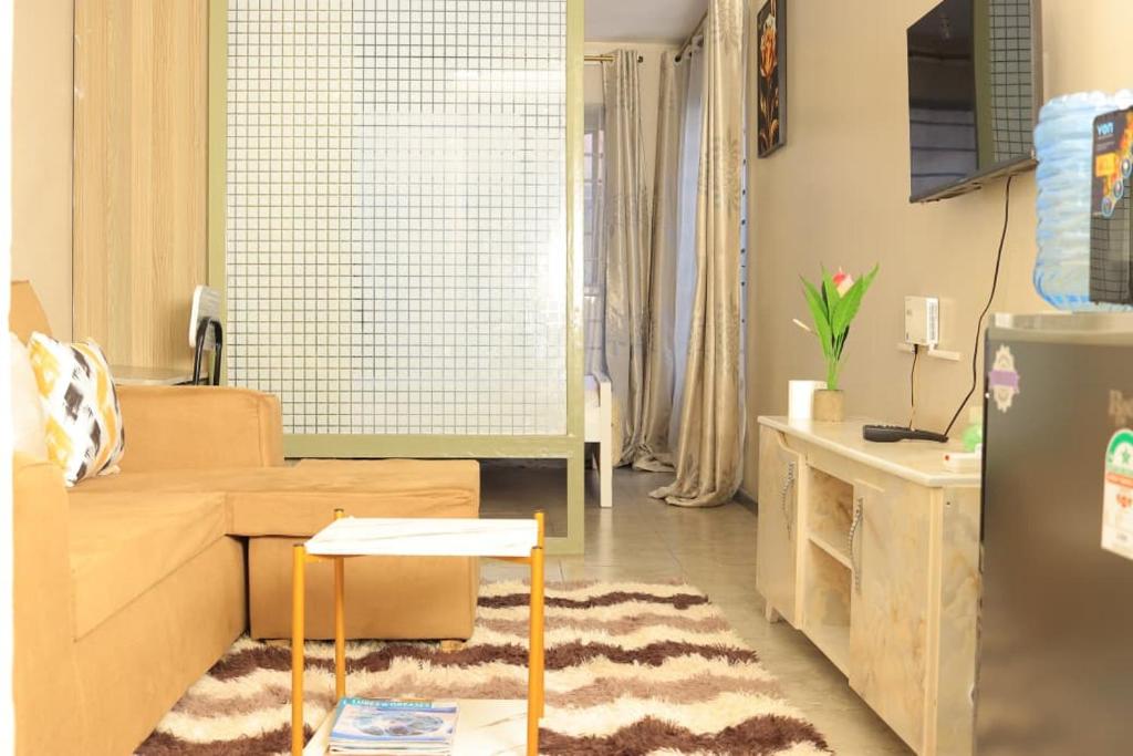 a living room with a couch and a table at Reggyhomes in Nairobi