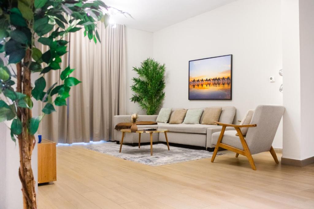 a living room with a couch and a table at Cool Summer Gateway At Yas in Abu Dhabi