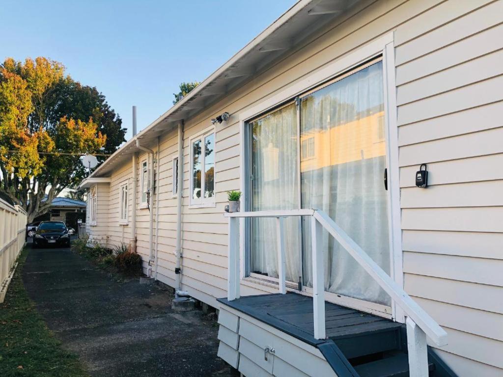 a porch on the side of a house at 4 Beds Including 1 Sofa Bed in 1 Bedroom plus1 Lounge in Auckland