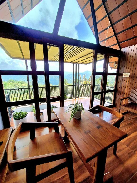 a large room with tables and chairs and large windows at Mount Lux Villa in Devāla