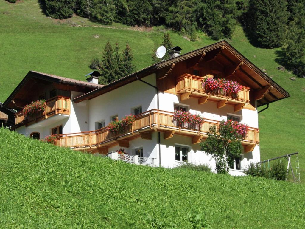 a house on a hill with flower boxes on it at Cozy apartment in Außervillgraten in Außervillgraten