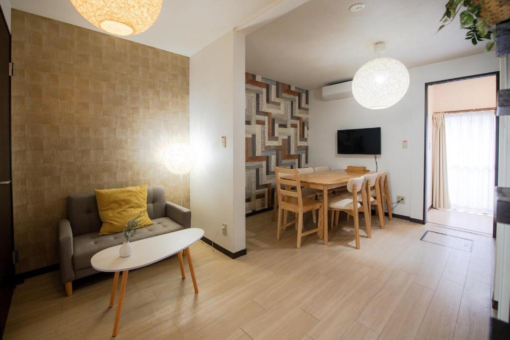a living room with a couch and a table at Rakuyodo Higahikujo in Kyoto