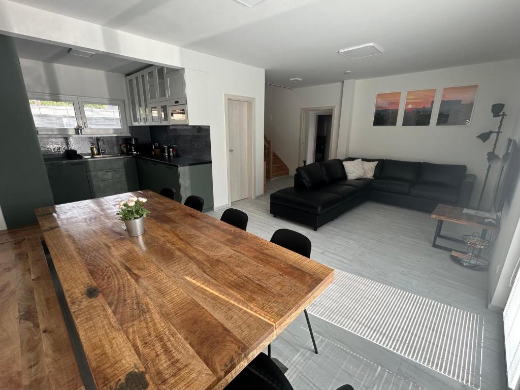 a living room with a wooden table and a couch at Holiday Home Prague Šeberov in Prague