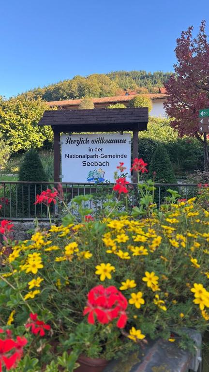 a sign in the middle of a garden with flowers at Bachnixe 1 in Seebach