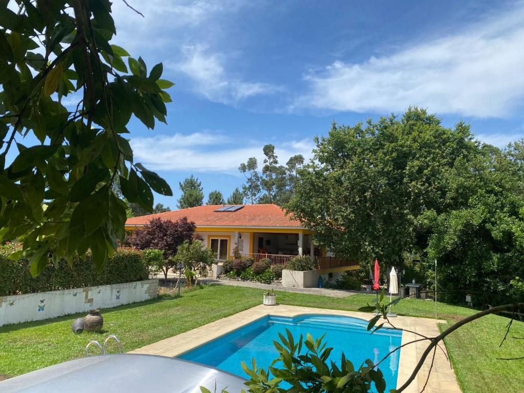 a house with a swimming pool in a yard at Casa dos Trigais in Marco de Canaveses