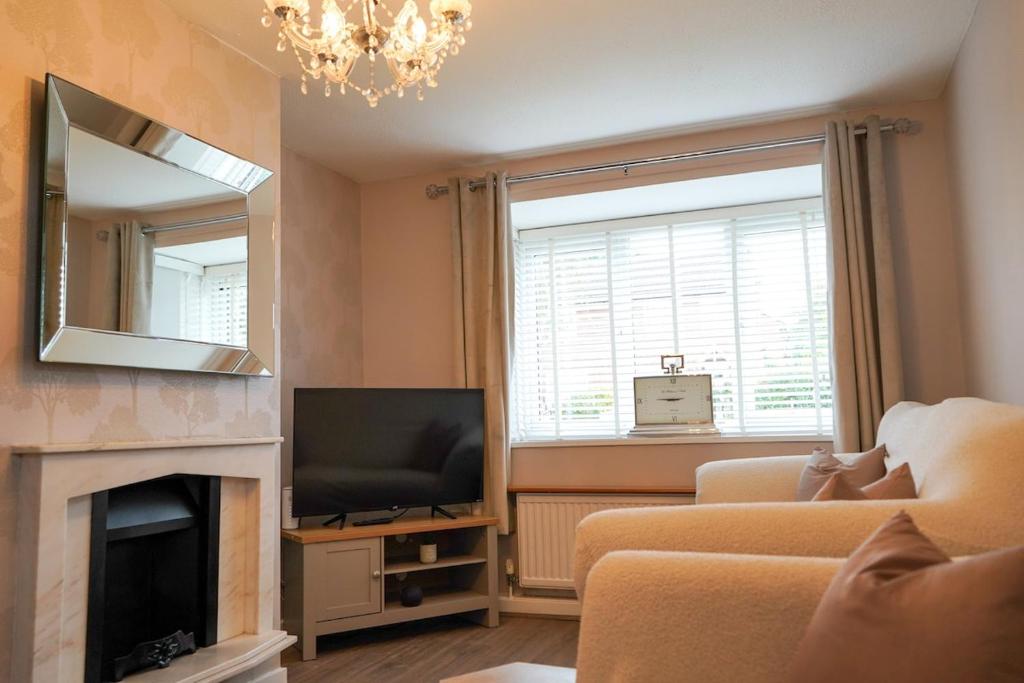 a living room with a television and a fireplace at The Townhouse Liverpool in Liverpool