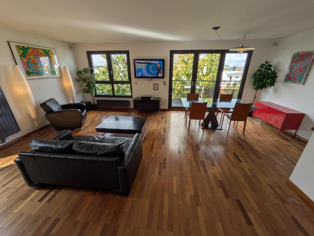 a living room with a couch and a table at Rooftop Luxembourg Ville in Luxembourg