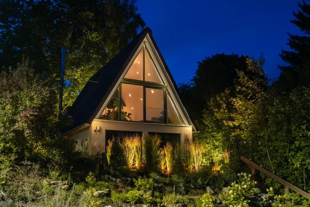 a small house lit up at night at Alva - Rhön Panorama Ferienhaus in Frankenheim