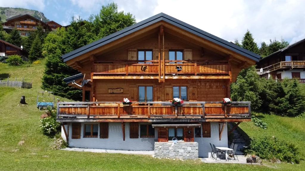 a large wooden house with a balcony at Chalet Ecureuil à Champoussin - Portes du Soleil in Champoussin