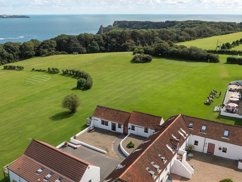 an aerial view of a house with a large green field at The Hayloft - Uk6715 in Lydstep