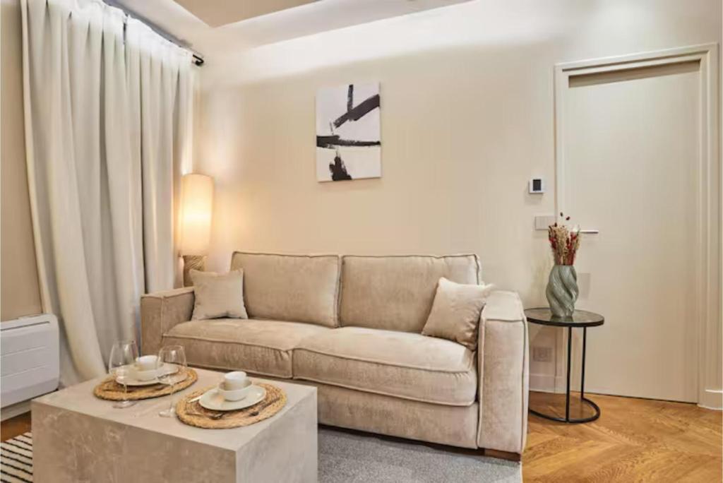 a living room with a couch and a table at Superb air-conditioned flat on the Champs Elysées in Paris