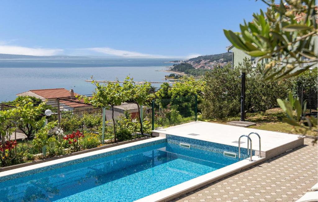 a swimming pool with a view of the ocean at Beach Front Home In Omis in Omiš