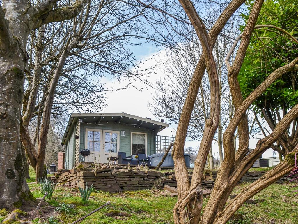 a small house in the middle of some trees at Ty Bach Twt - Uk36419 in Talybont