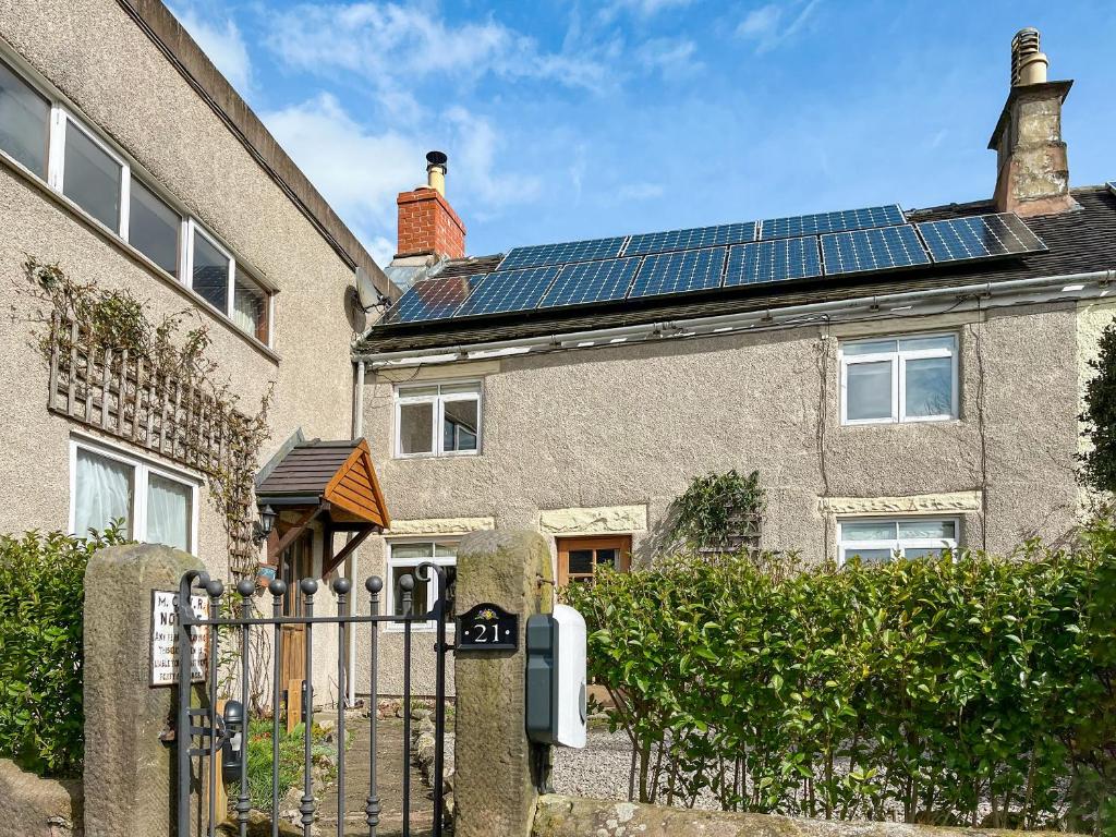 a house with solar panels on the roof at Bonsall View Cottage in Bonsall